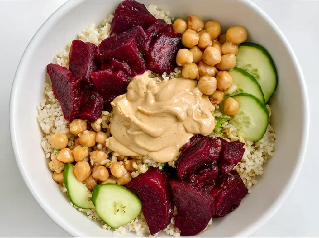 Quinoa bowl topped with canned pickled beets and tahini